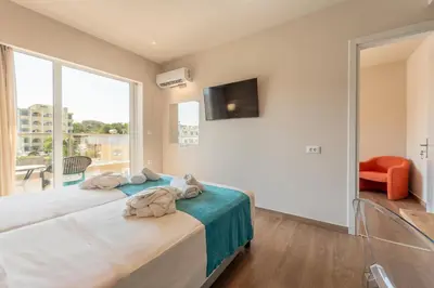 a bedroom with a large bed and a large window at Arte Hotel in Rhodes Town