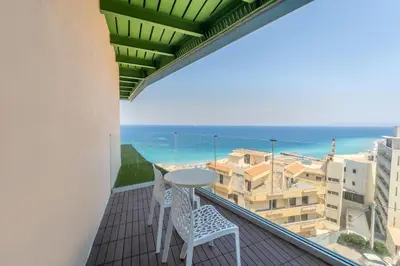 a balcony with a table and chairs and a view of the ocean at Arte Hotel in Rhodes Town