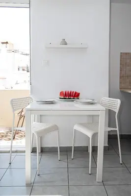 a white table and chairs in a white room at New Town Apartments in Rhodes Town