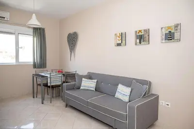 a living room with a couch and a table at New Town Apartments in Rhodes Town