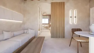 a living room with a white couch and a table at New Town Apartments in Rhodes Town