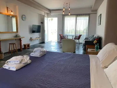 a bedroom with a large bed with two towels on it at Seascape Apartment with Private Balcony in Faliraki in Faliraki
