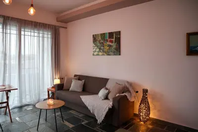 a living room with a couch and a table at Seascape Apartment with Private Balcony in Faliraki in Faliraki