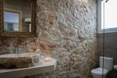 a bathroom with a sink and a mirror and a toilet at Seascape Apartment with Private Balcony in Faliraki in Faliraki