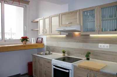 a kitchen with white cabinets and a sink and a window at Seascape Apartment with Private Balcony in Faliraki in Faliraki
