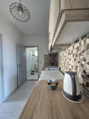a room with a bed and a bowl of fruit on a table at Maritina Apartments in Ixia