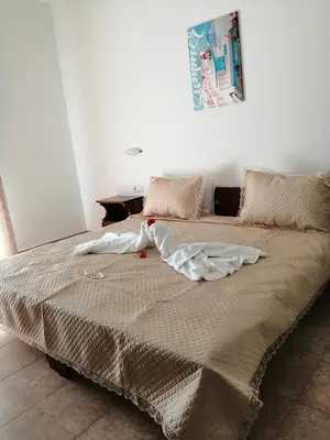 a large bed in a white room with at Stelios studios in Archangelos