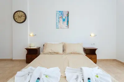 a bedroom with a bed with towels on it at Stelios studios in Archangelos