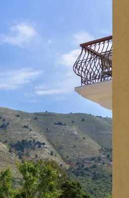 a view from a balcony of a building with a mountain at Asymi Residences in Symi