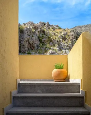 a vase sitting on the steps of a building at Asymi Residences in Symi