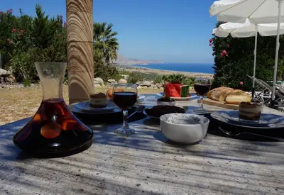 a table with glasses of wine and bread on it at Rhodes Demetrius Luxury Private Villa in Kalathos