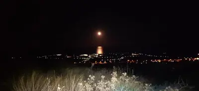 a view of a city at night with the moon at Rhodes Demetrius Luxury Private Villa in Kalathos