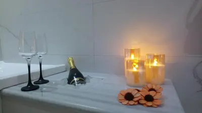 a bath tub with candles and wine glasses and flowers at Rhodes Demetrius Luxury Private Villa in Kalathos