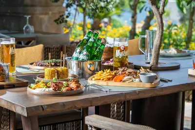 a wooden table with plates of food and drinks at Atrium Prestige Thalasso Spa Resort & Villas in Lachania