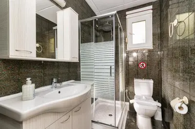 a bathroom with a sink and a toilet and a shower at Casa d' Acqua in Archangelos