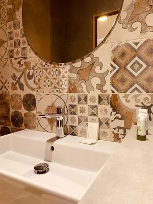 a bathroom with a white sink and a mirror at Argiro Village in Afantou