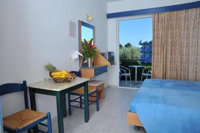 a bedroom with a table with a bowl of fruit on it at Argiro Village in Afantou
