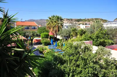 a view of a resort with a pool and trees at Argiro Village in Afantou
