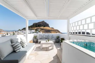 a patio with a view of the ocean at Lindian Polis in Líndos
