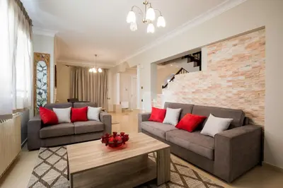 a living room with two couches and a table at GM Villa Kallithies Village in Kallithea Rhodes