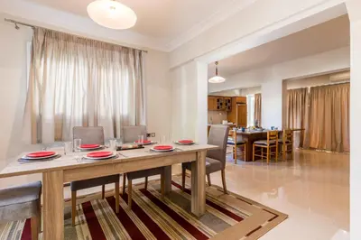 a dining room and living room with a table and chairs at GM Villa Kallithies Village in Kallithea Rhodes