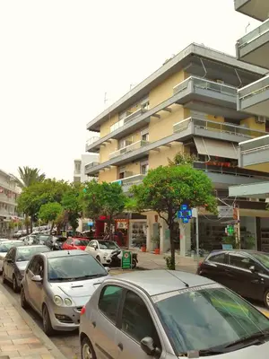 a parking lot with cars parked in front of a building at Unique Apartment in the Heart of the City in Rhodes Town