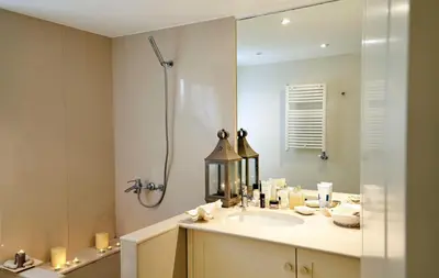 a bathroom with a sink and a shower and a mirror at Unique Apartment in the Heart of the City in Rhodes Town