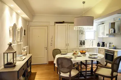 a kitchen with a table and chairs in a kitchen at Unique Apartment in the Heart of the City in Rhodes Town