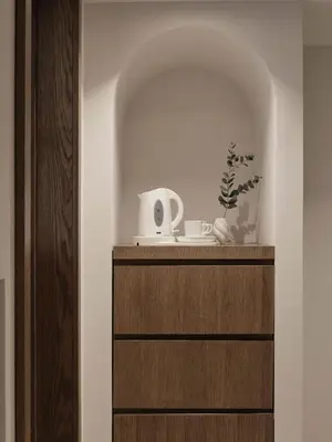 a room with a wooden cabinet with a white appliance at Lindos Princess Beach Hotel in Lardos