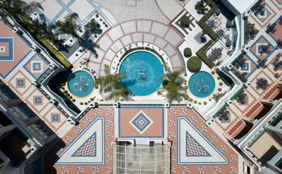 an overhead view of the pool at a resort at Lindos Princess Beach Hotel in Lardos