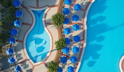 an overhead view of a swimming pool in a resort at Lindos Princess Beach Hotel in Lardos