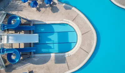 an overhead view of a pool at a water park at Lindos Princess Beach Hotel in Lardos