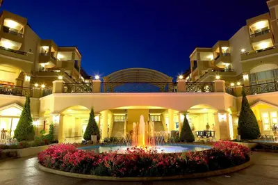 a hotel with a fountain in front of a building at Lindos Princess Beach Hotel in Lardos