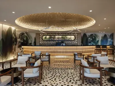 a restaurant with a large chandelier and tables and chairs at Rodos Princess Beach Hotel in Kiotari