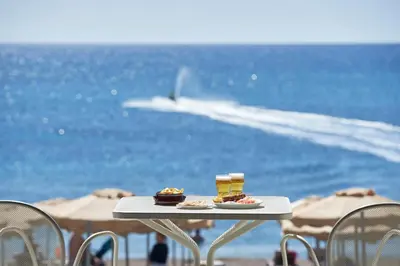 a table with food on it on the beach at Rodos Princess Beach Hotel in Kiotari