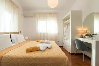 a bedroom with a large bed with two towels on it at Villa Dionysus in Gennadi