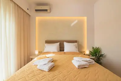 a bedroom with a large bed with towels on it at Villa Dionysus in Gennadi
