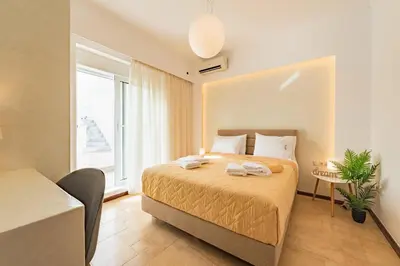 a bedroom with a bed and a large window at Villa Dionysus in Gennadi