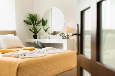 a bedroom with a bed with a mirror on the wall at Villa Dionysus in Gennadi
