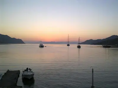 a group of boats in the water at sunset at Petridi House in Symi