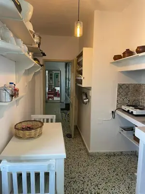a kitchen with a table with a basket on it at Petridi House in Symi