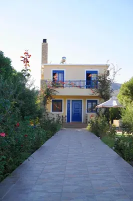 a house with a blue door and a walkway at The Blue Leaf Family Villa in Gennadi