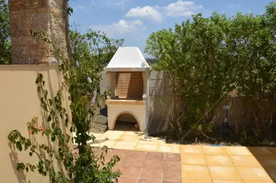 a dog house in the backyard of a house at The Blue Leaf Family Villa in Gennadi