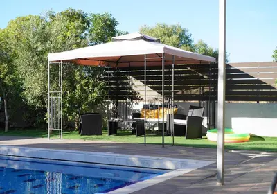 a white umbrella sitting next to a swimming pool at The Blue Leaf Family Villa in Gennadi
