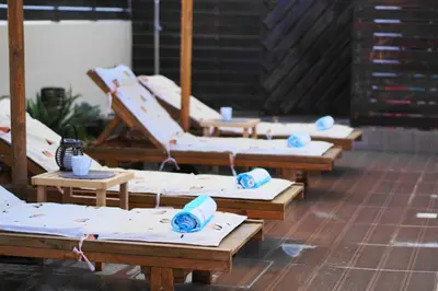 a row of wooden benches with blue bowls on them at The Blue Leaf Family Villa in Gennadi