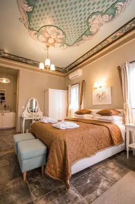 a bedroom with two beds and a ceiling at Symi Nautilus Luxury Suites in Symi