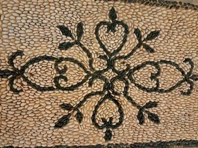 a blanket with a flower pattern on it at Symi Nautilus Luxury Suites in Symi