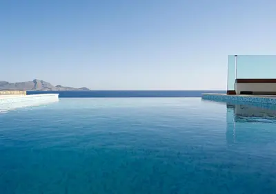 a swimming pool with blue water and the ocean at Luxury Villa Verna in Líndos