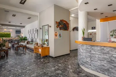 a lobby with couches and a bar at City Plus Rhodes Hotel in Rhodes Town