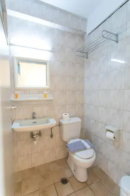 a bathroom with a toilet and a sink at City Plus Rhodes Hotel in Rhodes Town